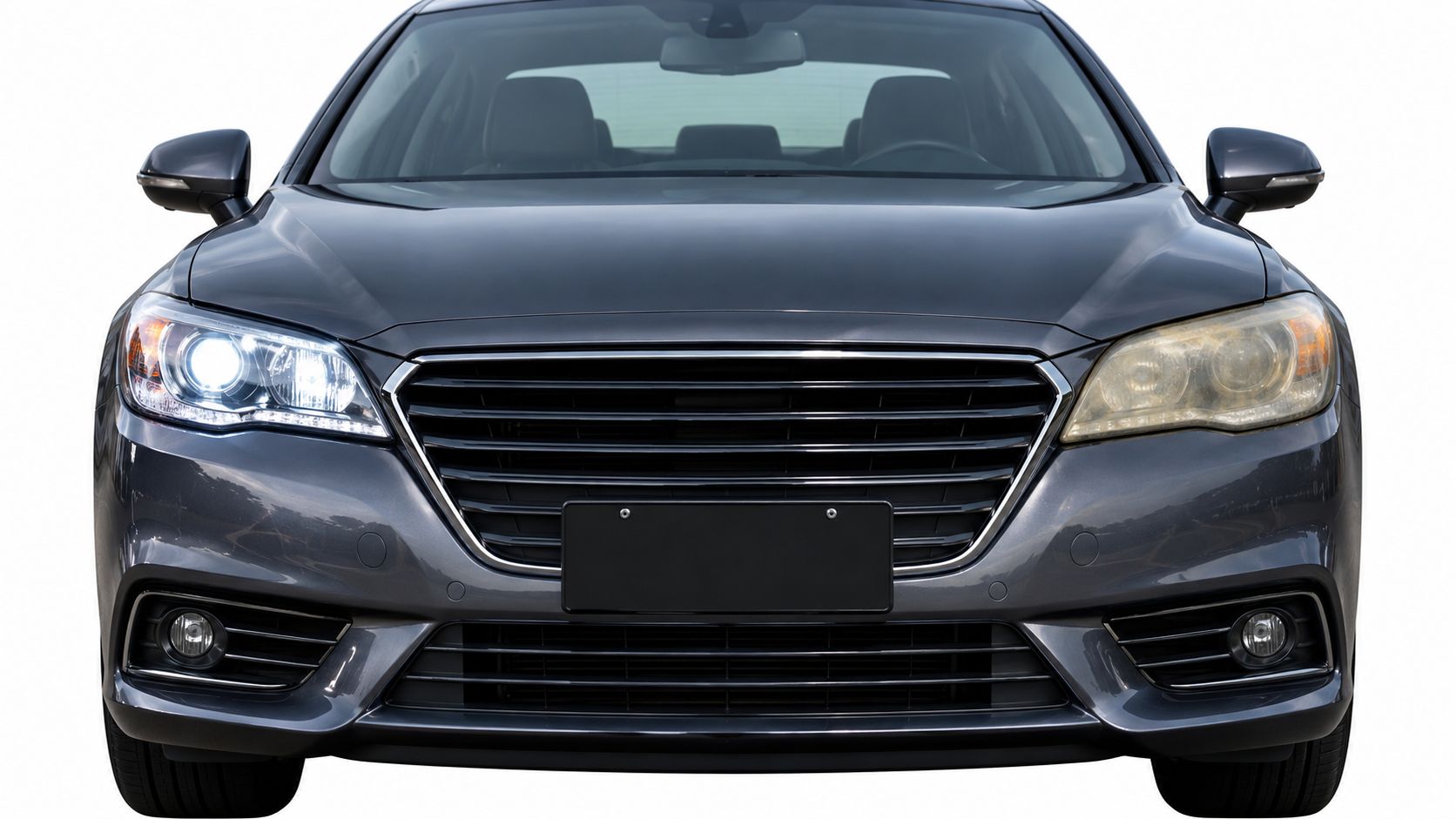 A front view of a grey car comparing a clear, restored headlight to a yellow, foggy headlight.