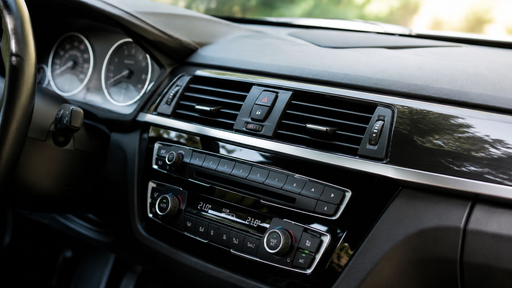 Close-up view of the interior dashboard, center console, and air vents of a modern luxury vehicle.